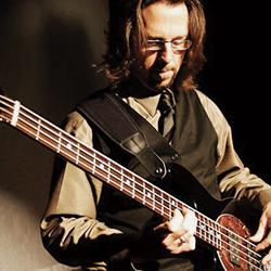 Michael Kelly playing bass guitar